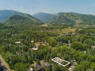 Nestled amidst lush greenery and mature trees, this property offers a serene mountain retreat.