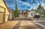 Discover this charming home featuring a welcoming facade with a stone retaining wall and a beautifully landscaped yard.