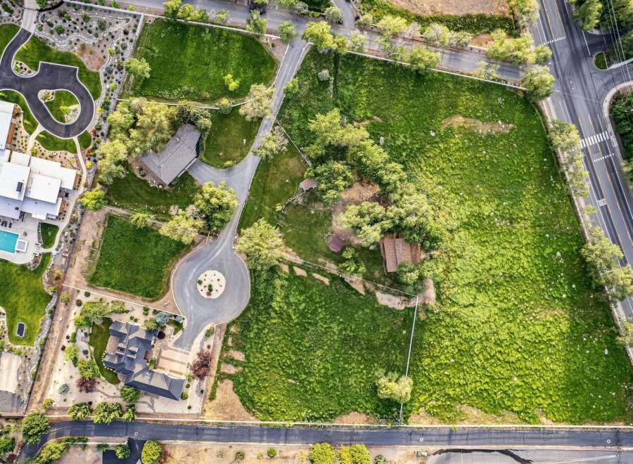 Discover this expansive estate featuring a modern residence with a sparkling pool and a separate guest house.