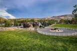 Experience luxury living in this stunning estate, featuring a beautiful home with a circular driveway and pristine white fencing.