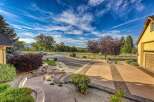 Discover this stunning property featuring a beautifully landscaped entrance with a winding walkway and stone steps, leading to a spacious driveway.