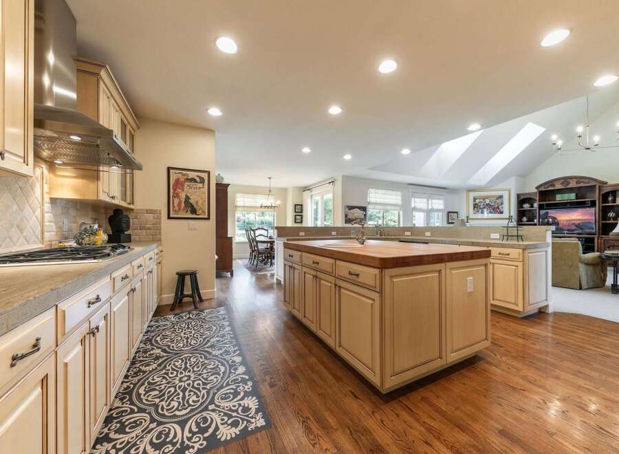 Experience the heart of this home with a spacious, open-concept kitchen featuring a large butcher block island perfect for meal prep and casual dining.