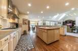 Experience the heart of this home with a spacious, open-concept kitchen featuring a large butcher block island perfect for meal prep and casual dining.