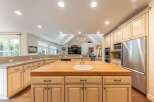 Experience the heart of this home with a spacious kitchen featuring a large butcher block island with a built-in sink, perfect for meal preparation and casual dining.