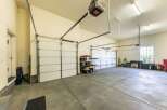 This spacious garage offers ample room for multiple vehicles and storage.