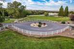 Discover this stunning property featuring a circular gravel driveway with a charming landscaped island, perfect for welcoming guests.