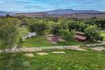 Discover this picturesque property featuring a charming white barn and a rustic wooden barn, perfect for equestrian enthusiasts or agricultural pursuits.