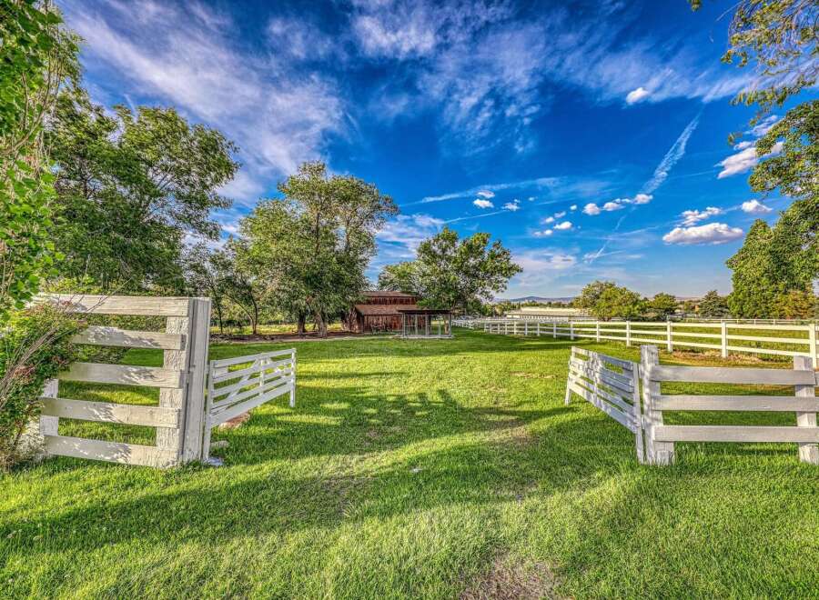 Discover this charming rural property featuring a classic red barn and a spacious, well-maintained pasture.