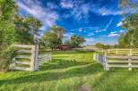 Discover this charming rural property featuring a classic red barn and a spacious, well-maintained pasture.