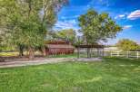 Discover this charming rural property featuring a rustic wooden barn and a spacious outdoor dog kennel, perfect for animal lovers.