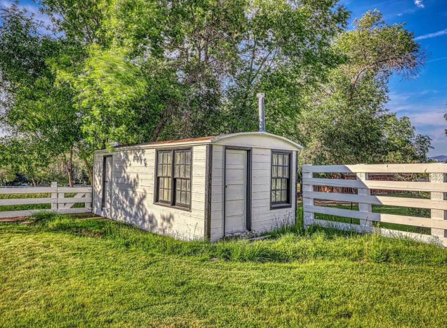 Discover this charming, rustic cabin nestled amidst lush greenery and mature trees.
