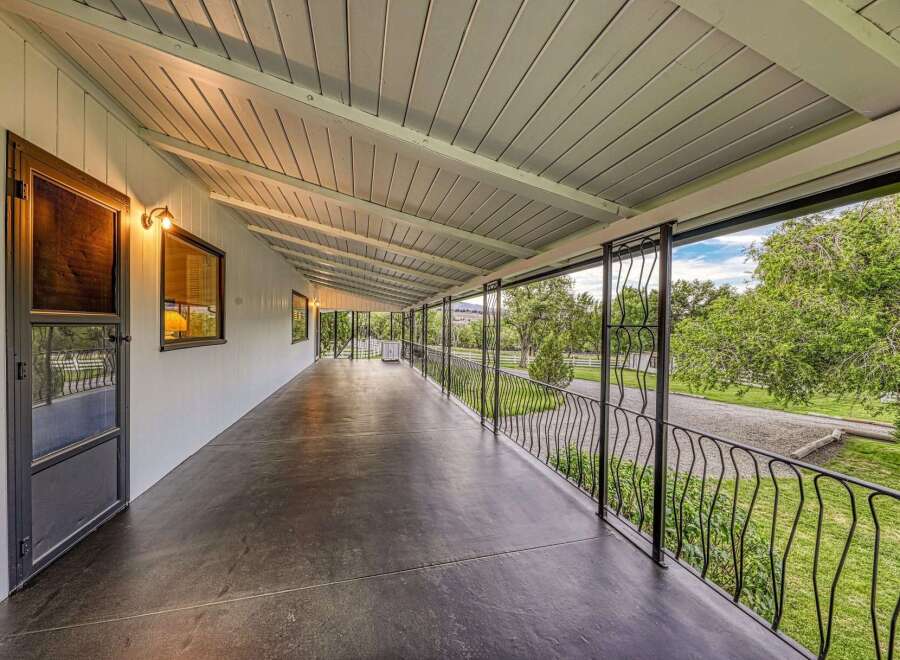 Enjoy the expansive covered porch of this charming property, offering a perfect blend of indoor-outdoor living.