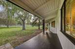 Enjoy the serene outdoors from the covered porch of this charming home.