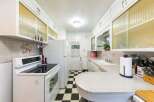 Step into this charming kitchen featuring a classic black and white checkered floor and ample white cabinetry.
