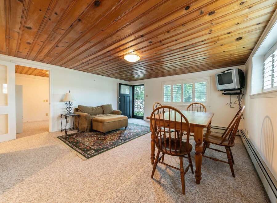 This cozy living space features a comfortable sofa with an ottoman, perfect for relaxing.