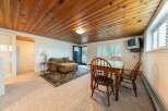 This cozy living space features a comfortable sofa with an ottoman, perfect for relaxing.