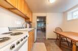 Discover this charming kitchen featuring warm wooden cabinetry and a classic white tiled backsplash.
