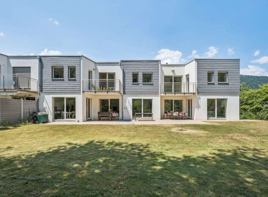 Discover modern living in this stunning townhouse featuring multiple balconies and expansive glass doors that flood the interiors with natural light.