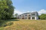 Discover modern living in this row of contemporary townhouses, featuring sleek grey siding and white stucco exteriors.