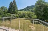 Enjoy breathtaking natural views from this property's balcony, featuring a modern stainless steel railing.