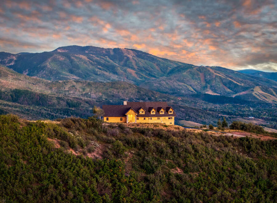 Experience luxury mountain living in this stunning timber-frame home, perched atop a scenic hillside with breathtaking panoramic views.