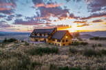 Experience breathtaking sunset views from this stunning log home, perched atop a hill with panoramic vistas of the valley and mountains.