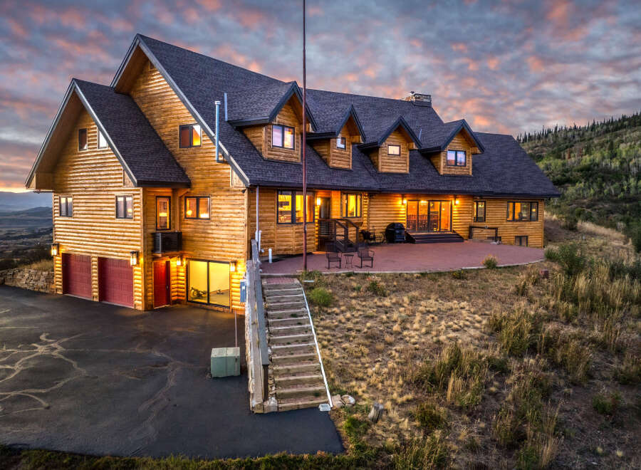 Experience luxury mountain living in this stunning log home, perfectly situated to capture breathtaking sunset views.