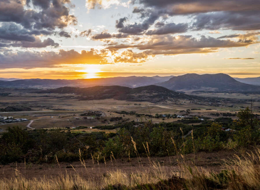Experience breathtaking sunset views from this elevated property, offering panoramic vistas of rolling hills and distant mountains.