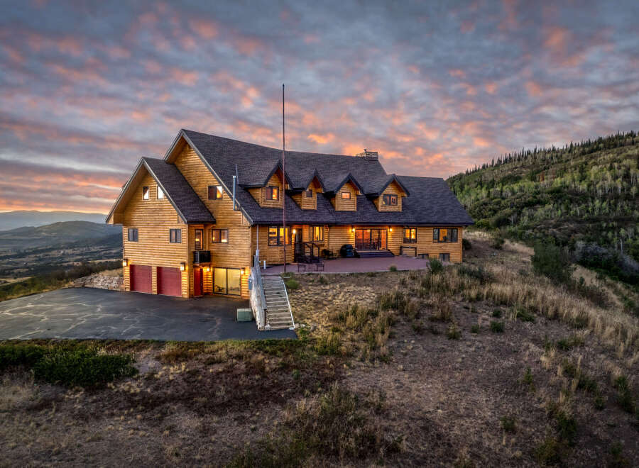 Experience breathtaking mountain living in this stunning log home, perfectly situated on a hilltop with panoramic views.