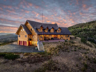 Experience breathtaking mountain living in this stunning log home, perfectly situated on a hilltop with panoramic views.