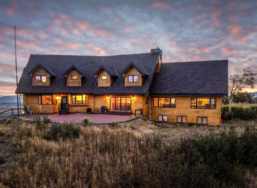 Experience luxury mountain living in this stunning log home, perfectly situated to capture breathtaking sunset views.