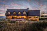 Experience luxury mountain living in this stunning log home, perfectly situated to capture breathtaking sunset views.