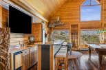 Experience ultimate relaxation in this stunning log cabin retreat, featuring a fully equipped bar area with granite countertops and a mini-fridge, perfect for entertaining.