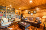 Step into a cozy den featuring rich wood paneling throughout, creating a warm and inviting atmosphere.