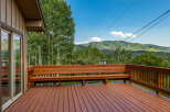 Enjoy breathtaking mountain views from this expansive wooden deck, perfect for outdoor entertaining or quiet relaxation.