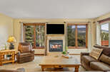 Cozy living room featuring a stone-tiled fireplace with a roaring fire, perfect for chilly evenings.