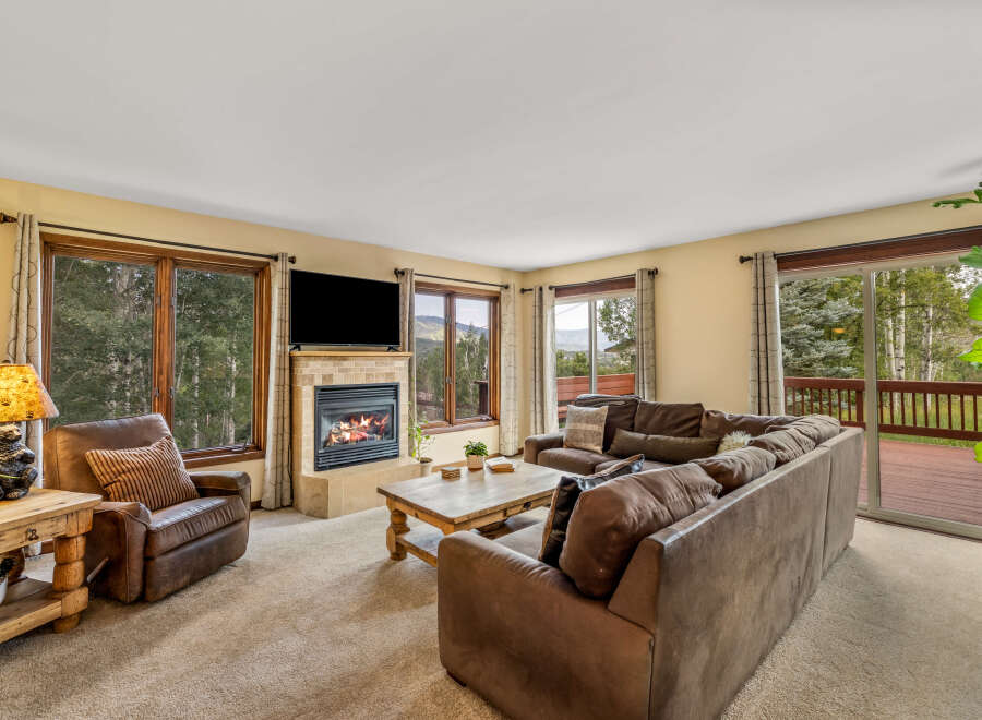 Experience cozy living in this inviting living room, featuring a warm fireplace and comfortable seating.