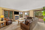 Experience cozy living in this inviting living room, featuring a warm fireplace and comfortable seating.