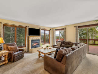 Experience cozy living in this inviting living room, featuring a warm fireplace and comfortable seating.