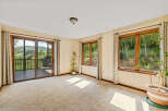 Experience breathtaking mountain views from this spacious room, featuring a large sliding glass door that opens to a private deck.