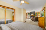 Experience ultimate comfort in this spacious bedroom featuring two cozy beds and a relaxing seating area with a fireplace.