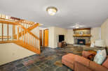 Cozy up by the stone fireplace in this inviting living space, featuring a rustic wooden mantel and a warm ambiance.