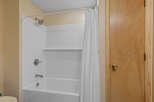 Step into this clean and inviting bathroom featuring a classic white subway tile shower and tub surround.