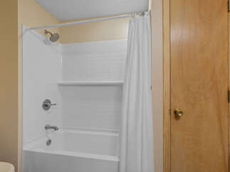 Step into this clean and inviting bathroom featuring a classic white subway tile shower and tub surround.