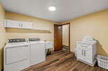 This spacious laundry room features a washer, dryer, and utility sink for all your cleaning needs.