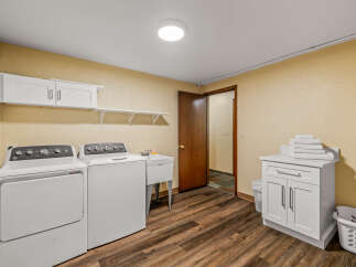 This spacious laundry room features a washer, dryer, and utility sink for all your cleaning needs.