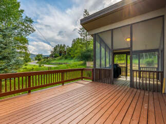 Enjoy stunning mountain views from this expansive wooden deck, perfect for outdoor entertaining.
