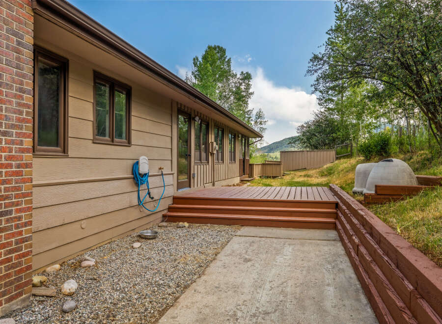 Enjoy outdoor living with this spacious deck and patio area, perfect for entertaining or relaxing.