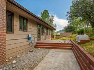 Enjoy outdoor living with this spacious deck and patio area, perfect for entertaining or relaxing.