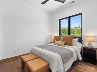 This inviting bedroom features a comfortable queen-size bed adorned with plush pillows and a decorative throw.